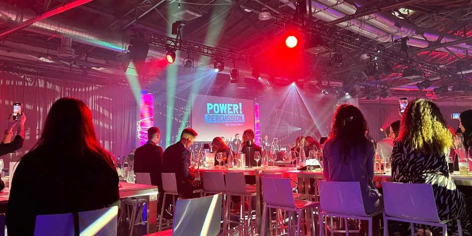 Veranstaltungstechnik mit Bühne, Licht und Publikum bei einem Firmenevent